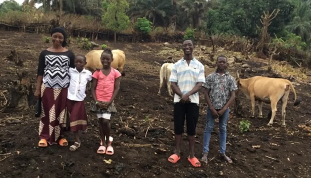 Amidu and his family at the cowshed.